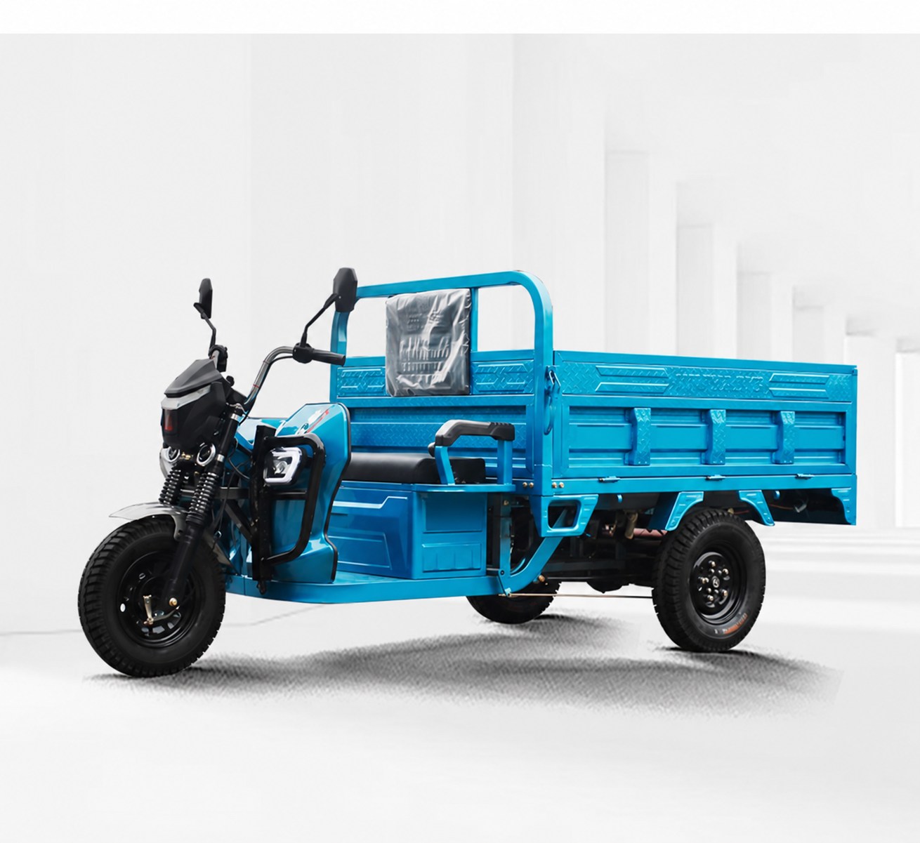 Blue open cargo electric tricycle with a rear cargo bed